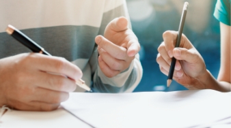 Man and woman filling out forms